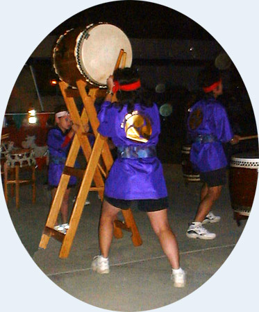 Check out the girl bracing the drum stand...